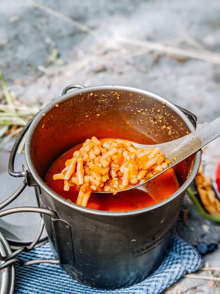 Cooking a delicious meal in a reusable metal pot, demonstrating one of my favorite zero waste swaps for reducing single-use plastic and embracing sustainable living.