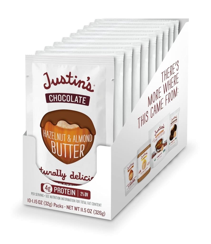 A box of Justin's Chocolate Hazelnut Butter squeeze packs, perfect for a tasty, travel-friendly snack you can bring on an airplane.