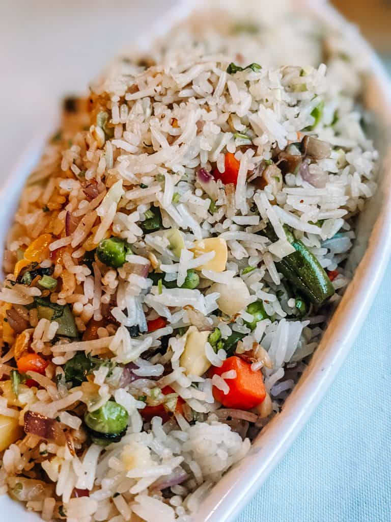 This plate of vegetable fried rice, enjoyed during my visit to the City of Big Bear, is a mix of fluffy rice, colorful bell peppers, green beans, and peas. The vegetables add a fresh crunch, perfectly complementing the savory, aromatic rice.