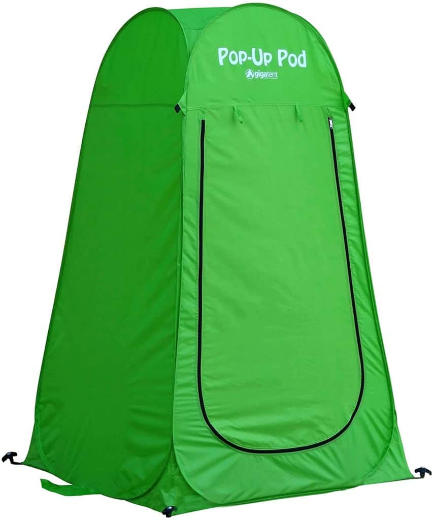 A green Pop-Up Pod, a portable privacy tent ideal for camper conversion vans, providing a private space for showering, changing clothes, or using a portable toilet while on the road.