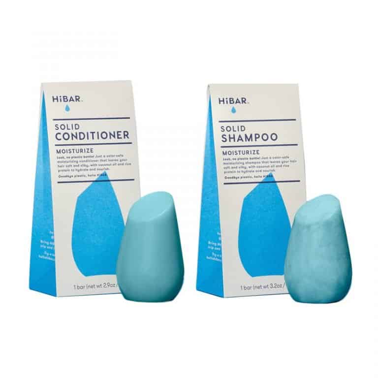 A two Hibar products, a blue solid shampoo bar and a blue solid conditioner bar, both in minimalist packaging. These eco-friendly hair care products are ideal for a sustainable gift guide.