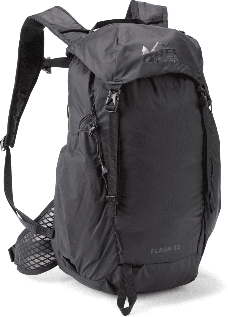 A black REI Co-op Flash 22 backpack, a compact and lightweight option ideal for carrying hike essentials on outdoor adventures.