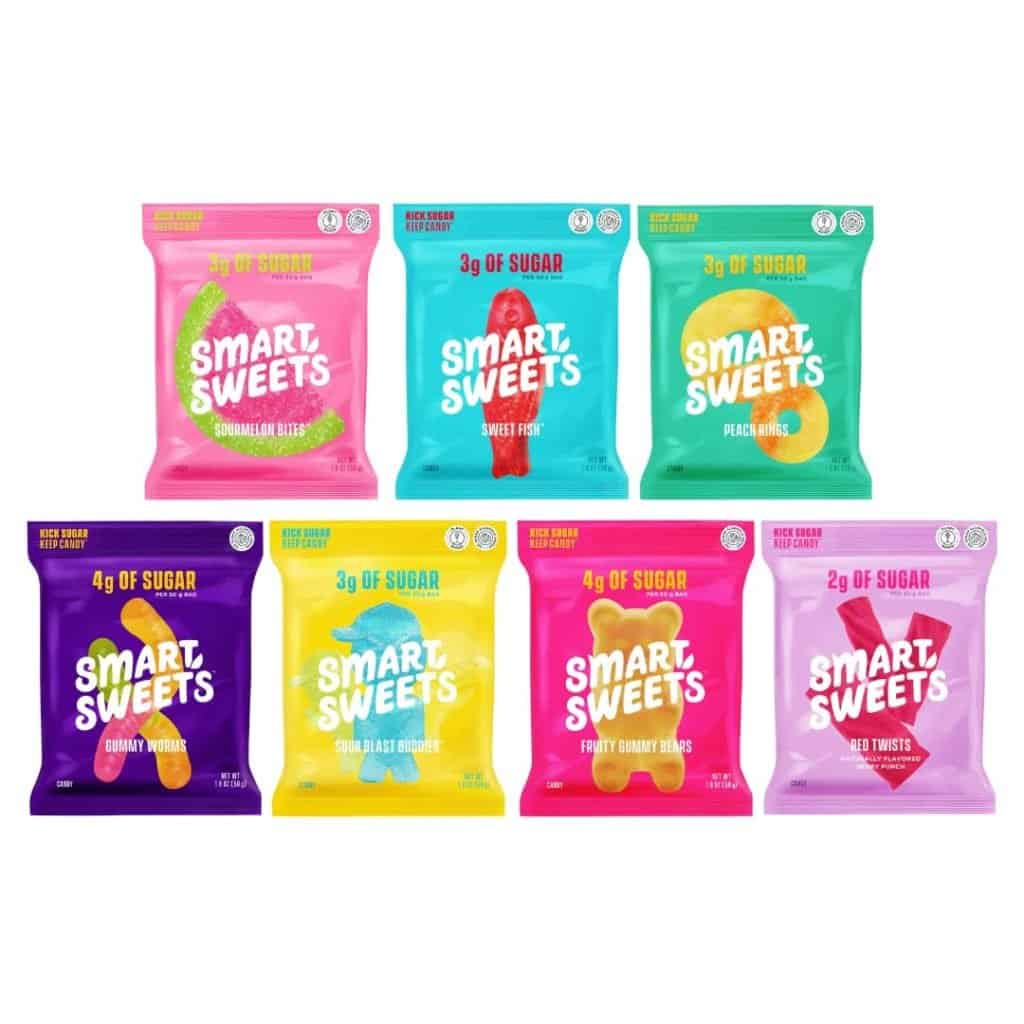 A colorful assortment of SmartSweets candy packs, which are low-sugar, travel-friendly snacks you can bring on an airplane to satisfy your sweet tooth.