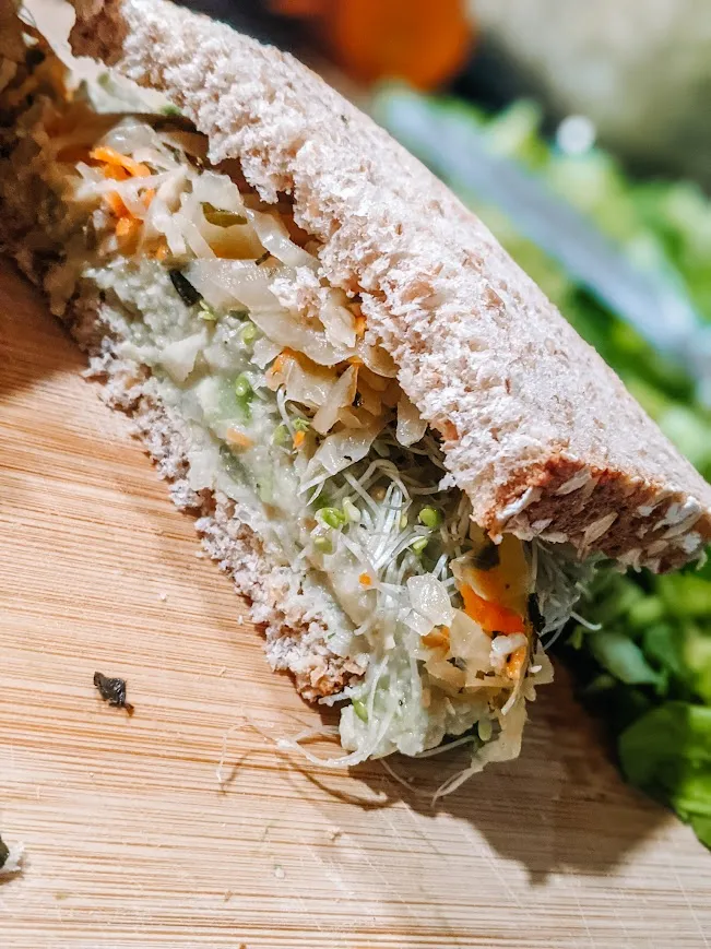 Packed with crunchy sprouts, tangy sauerkraut, and creamy avocado spread, all nestled between hearty whole grain bread. This nutritious and delicious sandwich is perfect for keeping me energized during long drives, making it one of the best road trip foods.