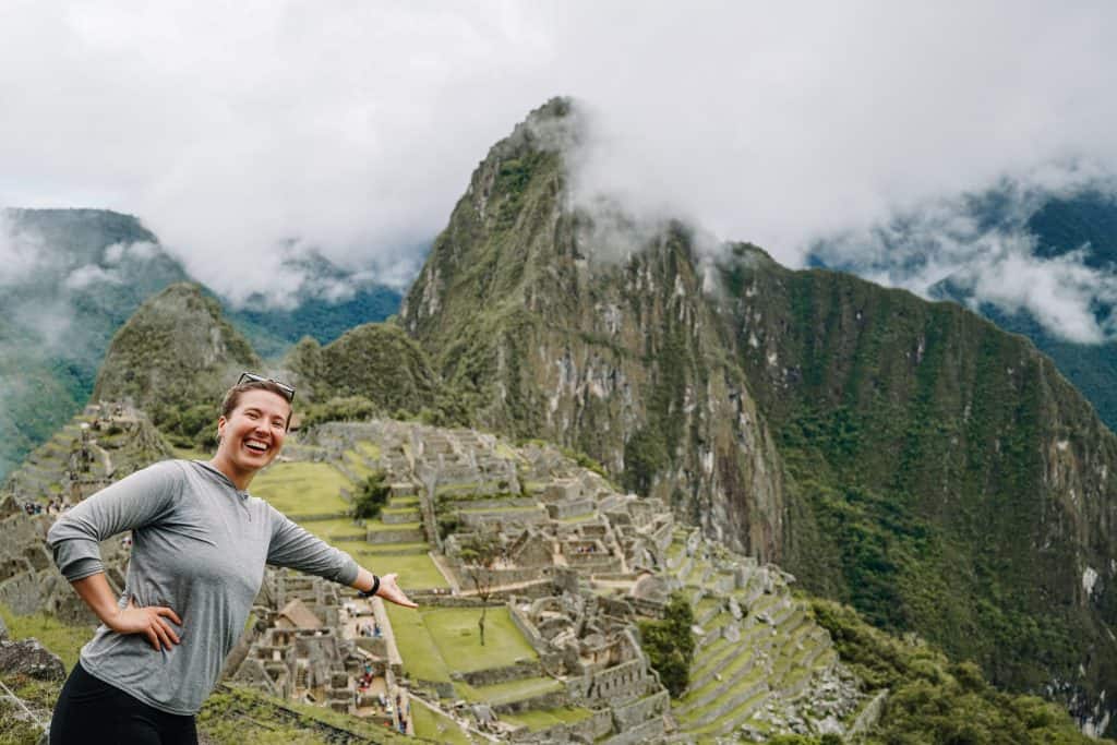 Here I am standing at one of the iconic viewpoints at Machu Picchu, pointing to the breathtaking ruins below. Exploring the ancient Incan citadel is one of the top things to do at Machu Picchu.