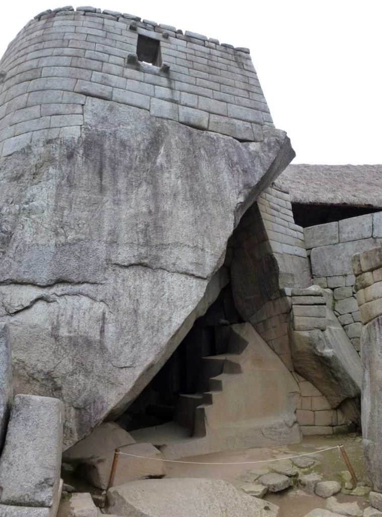 The Temple of the Sun at Machu Picchu, an ancient structure built with impressive stone masonry. One of the key things to do at Machu Picchu is exploring this temple, which features a curved wall and finely cut stones.