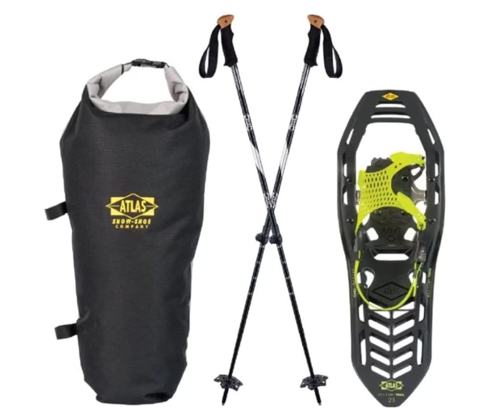 For your hot springs packing list, consider bringing snowshoes and trekking poles like these to navigate snowy terrain. The set includes a black carry bag, two poles, and one snowshoe with bright green accents.