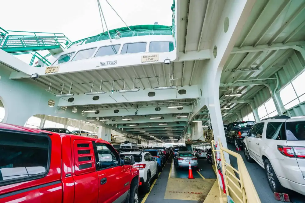 Cars parked inside a ferry, often used by visitors traveling to Shi Shi Beach Olympic National Park, with upper deck visible above.